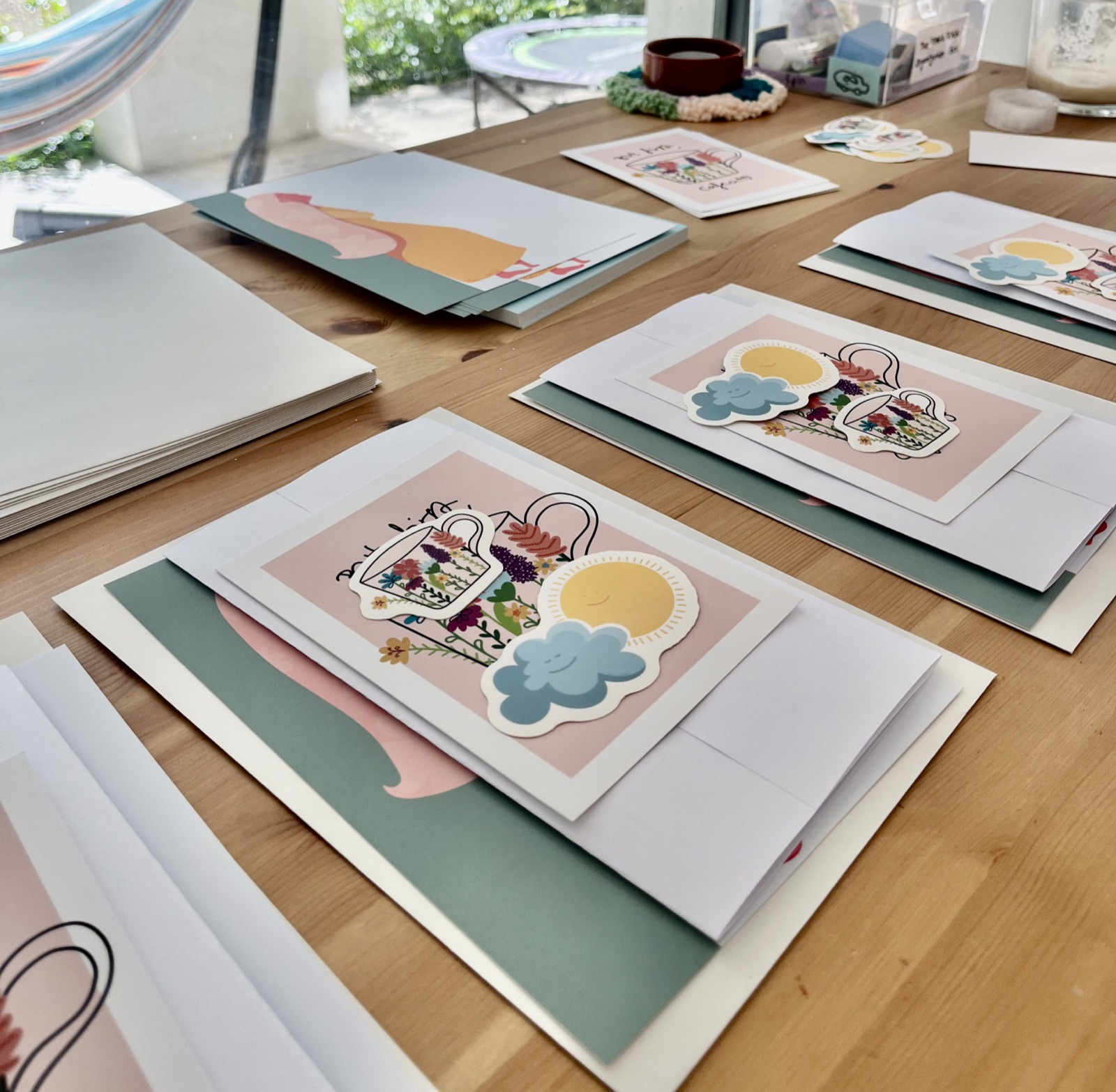 Camila’s art prints and stickers laid out on the table